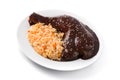 Traditional mole Poblano with rice in plate isolated