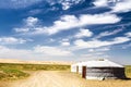 Traditional Mongolian yurt and a pair of cows during a sunset. Gobi Desert, Mongolia.