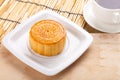 Traditional moon cakes on table setting with teacup.