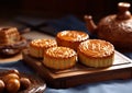 Traditional mooncakes pastry with tea on wooden table.Macro.AI Generative