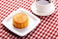 Traditional mooncakes on table setting with cup. Royalty Free Stock Photo