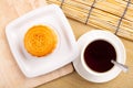 Traditional mooncakes on table setting with teacup. Royalty Free Stock Photo