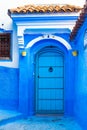 Traditional moroccan door in blue town Chefchaouen, Morocco. Vertical Royalty Free Stock Photo