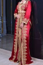 Traditional Moroccan dress. A model wearing a red Moroccan caftan