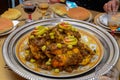 Traditional moroccan tajine with chicken,pototoes and olives close up.