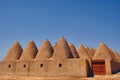 Beehive houses opposite bright clear sky