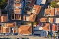 Traditional multicolored historic Greek houses with beautiful roofs of island city top view from drone. dense buildings with Royalty Free Stock Photo