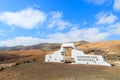 Traditional municipality sign white arch gate near Betancuria village with desert landscape in the background, Fuerteventura, Royalty Free Stock Photo