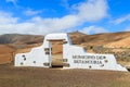 Traditional municipality sign white arch gate near Betancuria village with desert landscape in the background, Fuerteventura, Royalty Free Stock Photo