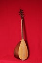 Traditional musical instrument baglama saz isolated on a red background. Royalty Free Stock Photo