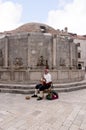 Traditional Musician by Onofrono Fountain in Dubrovnic in Croatia Europe Royalty Free Stock Photo