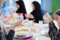 Traditional muslim family praying before iftar dinner Royalty Free Stock Photo