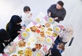 Traditional muslim family praying before iftar dinner Royalty Free Stock Photo