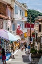 Traditional Narrow Alley with Gift Shops and Souvenirs in the Town of Parga, Western Greece. People Enjoy Vacation and Shopping