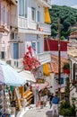 Traditional Narrow Alley with Gift Shops and Souvenirs in the Town of Parga, Western Greece. People Enjoy Vacation and Shopping