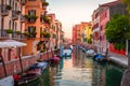 Traditional narrow canal with gondolas in Venice, Italy