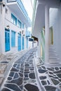 traditional narrow street in Mykonos with blue doors and white walls Royalty Free Stock Photo