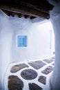 traditional narrow street in Mykonos with blue doors and white walls Royalty Free Stock Photo