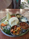 Traditional Nepalese dal bhat served with steamed rice and lentil soup