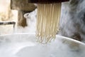Traditional noodles making on a vintage machine