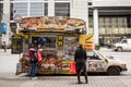 Traditional North American food truck with people ordering food in Downtown Toronto, Ontario, selling burgers, fries and poutine i