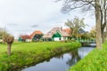 Traditional North-Holland farmhouse with bridge and ditch