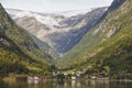 Traditional norwegian fjord village with glacier. Hardanger rout Royalty Free Stock Photo