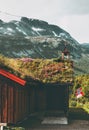 Traditional norwegian house with grass on roof and mountains landscape on background Royalty Free Stock Photo