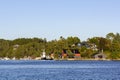 Traditional Norwegian house surrounded by trees and near the sea Royalty Free Stock Photo