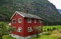 Traditional Norwegian red-white wooden house in the background of a fjord at Flam Royalty Free Stock Photo