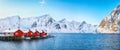 Traditional Norwegian red wooden houses rorbuer on the shore of  Reinefjorden near Hamnoy village Royalty Free Stock Photo