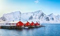 Traditional Norwegian red wooden houses rorbuer on the shore of  Reinefjorden near Hamnoy village Royalty Free Stock Photo