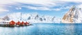 Traditional Norwegian red wooden houses rorbuer on the shore of  Reinefjorden near Hamnoy village Royalty Free Stock Photo