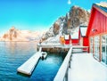 Traditional Norwegian red wooden houses rorbuer on the shore of  Reinefjorden near Hamnoy village Royalty Free Stock Photo