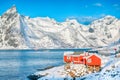 Traditional Norwegian red wooden houses on the shore of Reinefjorden in Hamnoy villa