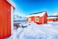 Traditional Norwegian red wooden houses on the shore of Reinefjorden in Hamnoy village