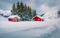 Traditional Norwegian red wooden houses under the fresh snow. Royalty Free Stock Photo