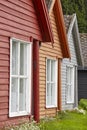 Traditional norwegian wooden colored cabin houses facades. Travel Norway Royalty Free Stock Photo