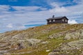 Traditional norwegian wooden house with solar panels in Norway mountains Royalty Free Stock Photo