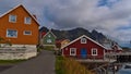 Traditional Norwegian wooden houses in village HenningsvÃÂ¦r, Lofoten, Norway with facades painted in red, orange and green colors. Royalty Free Stock Photo
