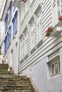 Traditional norwegian wooden white facades. Antique street in Be