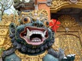 Traditional old ancient Balinese statue of demon angel called barong bali guarding sacred ritual temple