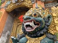 Traditional old ancient Balinese statue of demon angel called barong bali guarding sacred ritual temple Royalty Free Stock Photo