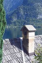 Traditional old austrian wooden house in Hallstatt, Austria. The roof of the house on the background of the Austrian mountains. Royalty Free Stock Photo