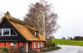 Traditional old country house with thatched straw roof in Denmark Royalty Free Stock Photo