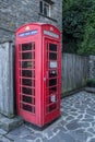 Traditional old English phone booth with the modern technologies Royalty Free Stock Photo