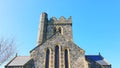 Traditional old historic church architecture found in the UK against a clear blue sky