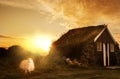 A traditional old house with a roof overgrown with grass and a tent on the beach. Iceland Royalty Free Stock Photo