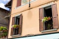 Traditional old house with wooden blue shutters and twisted balcony . Tourist attraction Monte Isola, Italy Royalty Free Stock Photo
