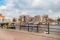 Traditional old houses, canal, bridge, bikes in Amsterdam, Netherlands